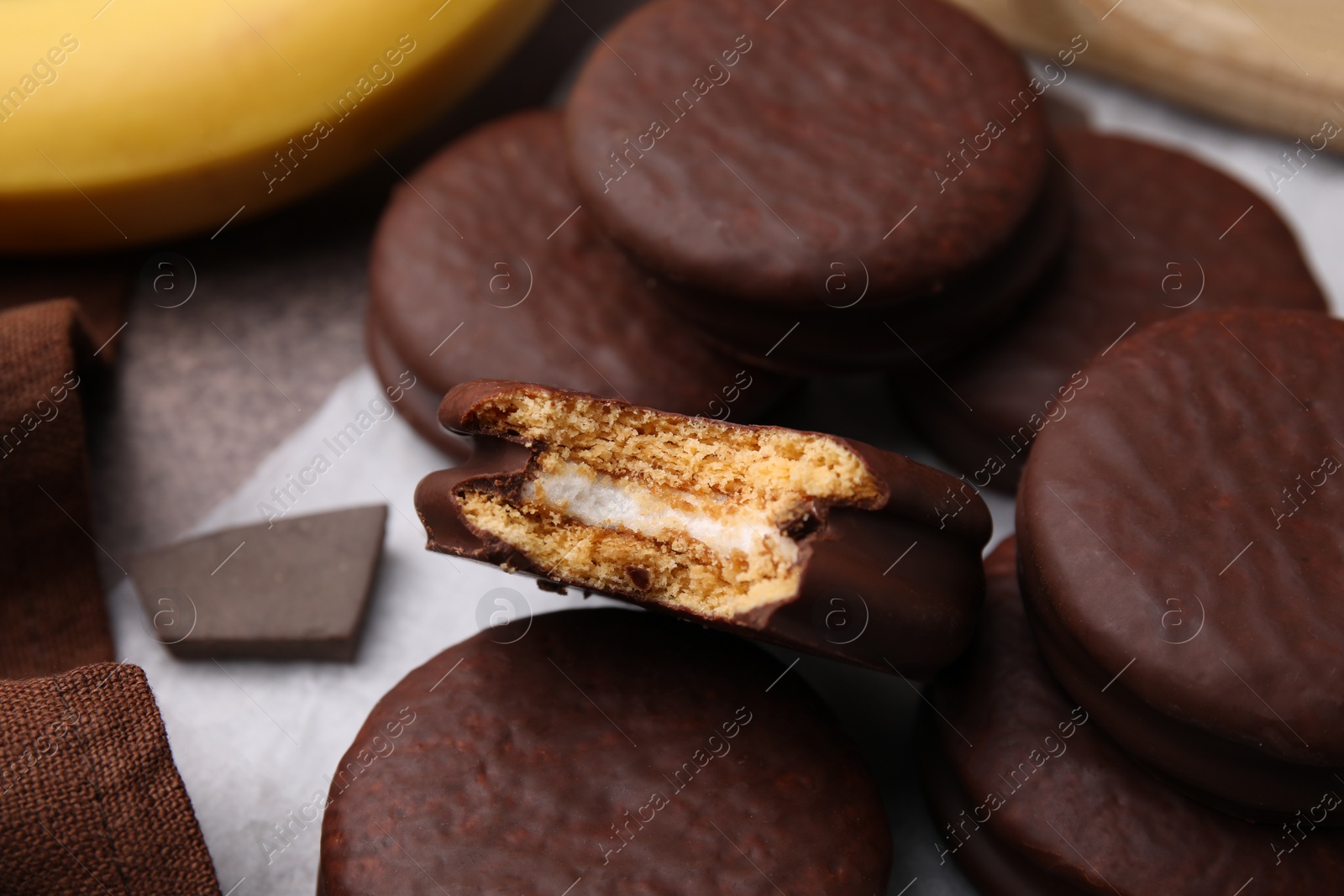 Photo of Tasty banana choco pies on table, closeup