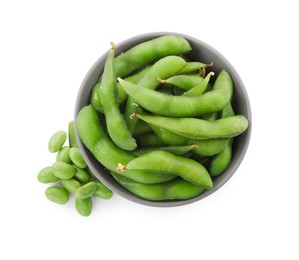 Bowl with green edamame pods and beans on white background, top view