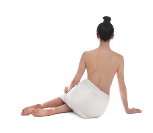 Back view of woman with perfect smooth skin sitting on white background