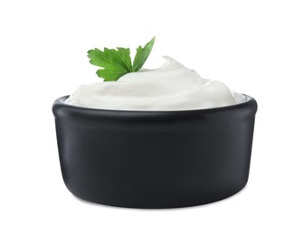 Delicious sour cream with parsley in black bowl on white background