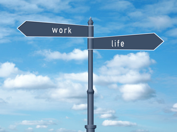 Image of Signpost against beautiful blue sky. Concept of balance between work and life