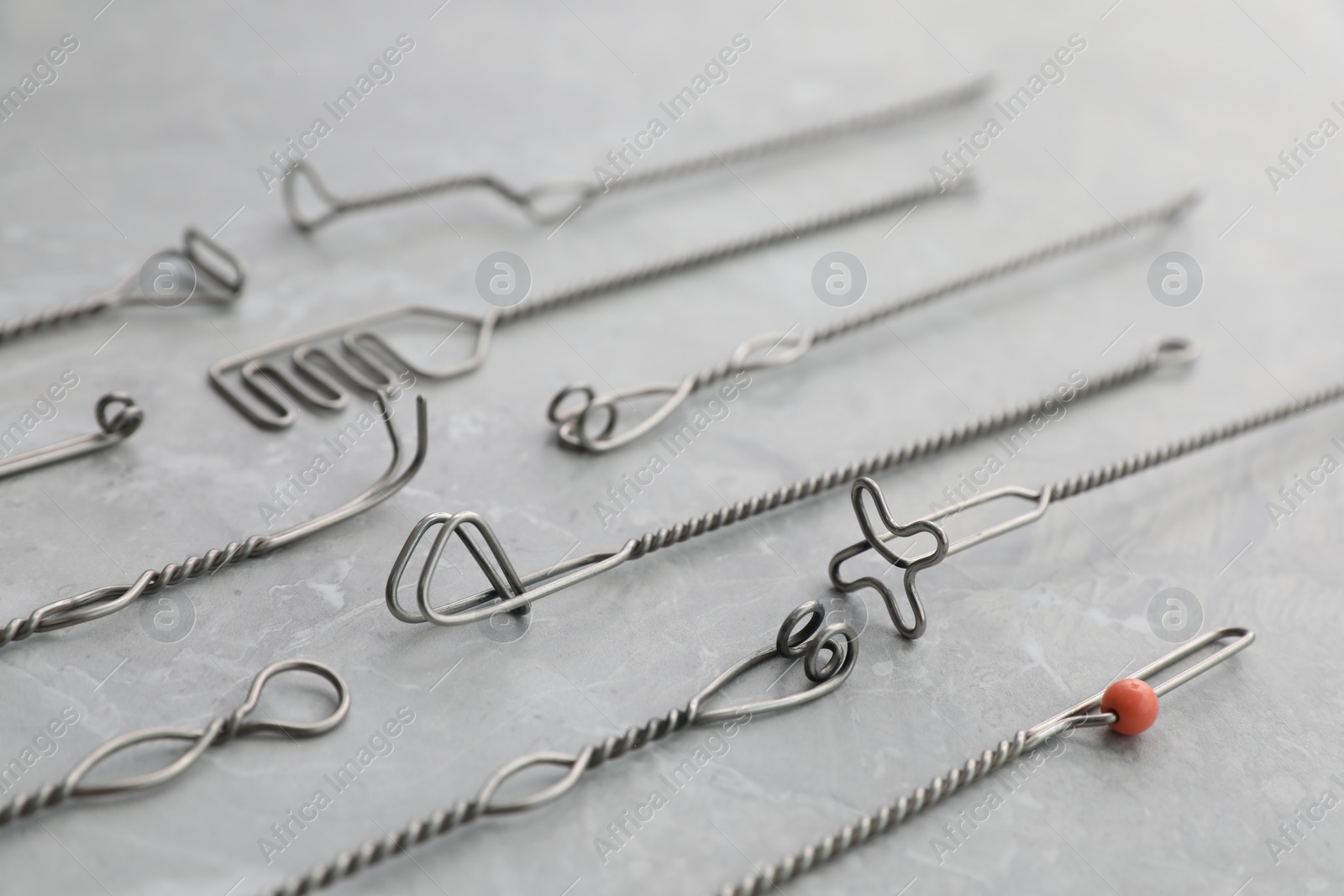 Photo of Set of different logopedic probes on marble table. Speech therapist's tools