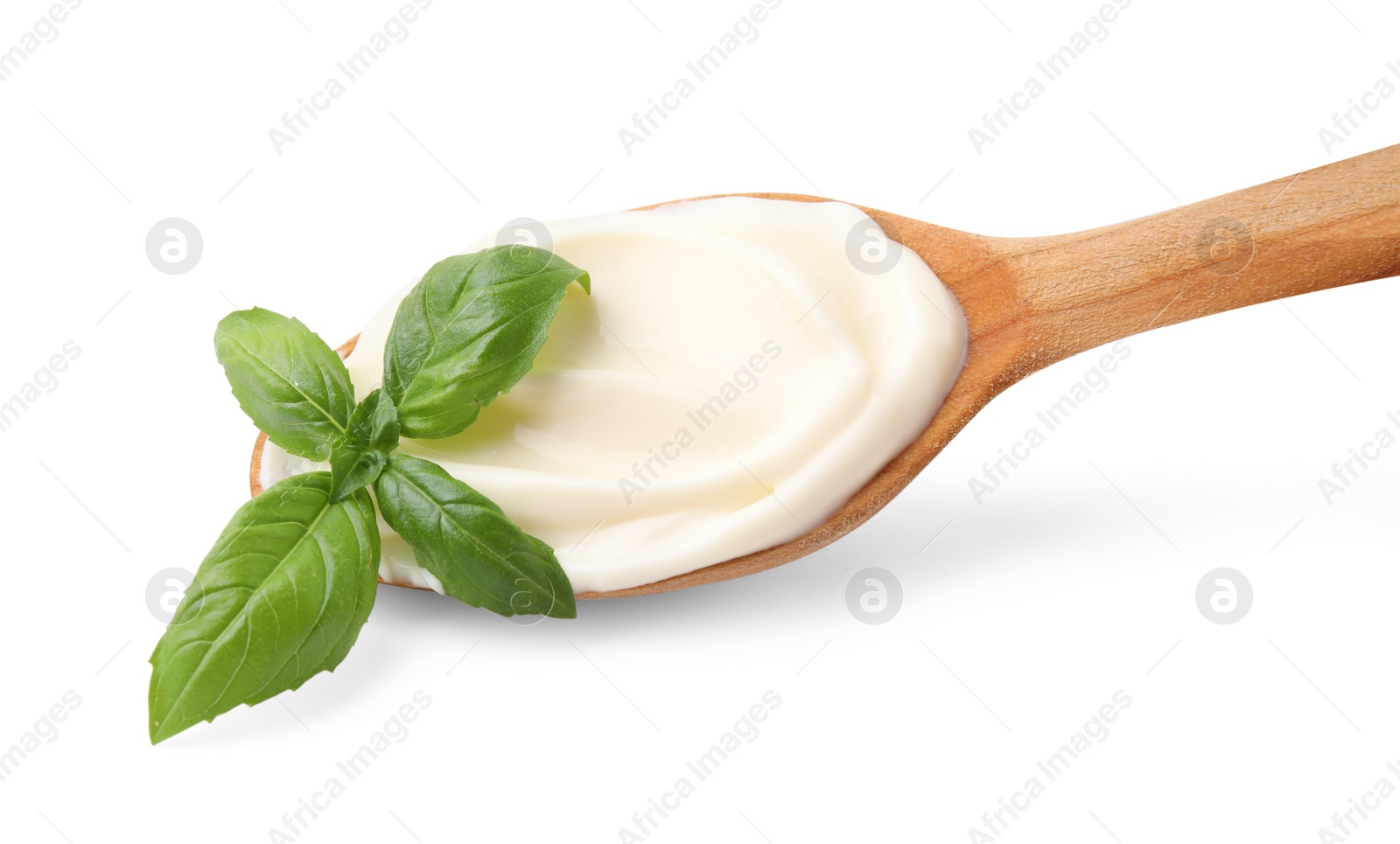 Photo of Wooden spoon with tasty mayonnaise and basil isolated on white