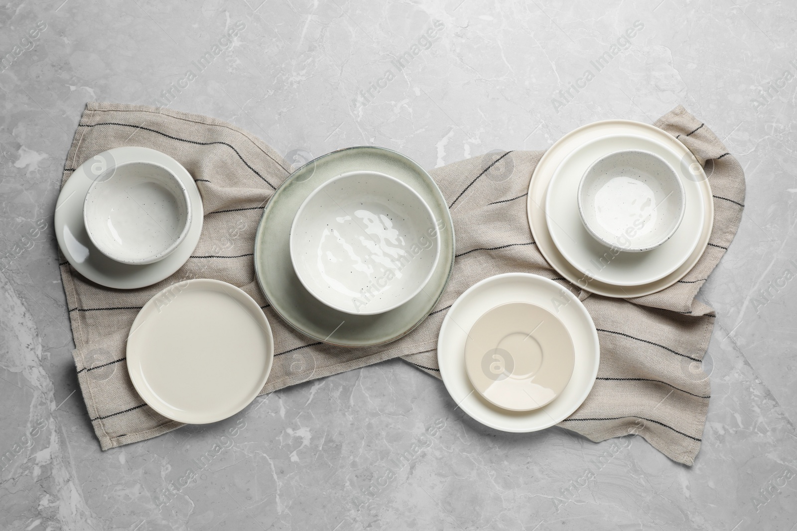 Photo of Set of clean tableware on grey table, flat lay
