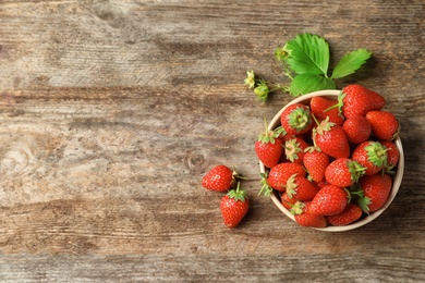 Flat lay composition with fresh strawberries on wooden background