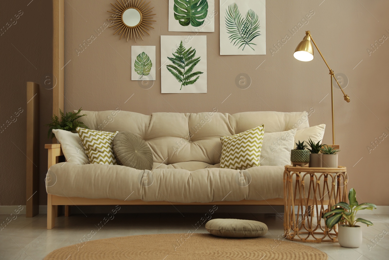 Photo of Stylish living room interior with comfortable sofa and beautiful pictures on wall
