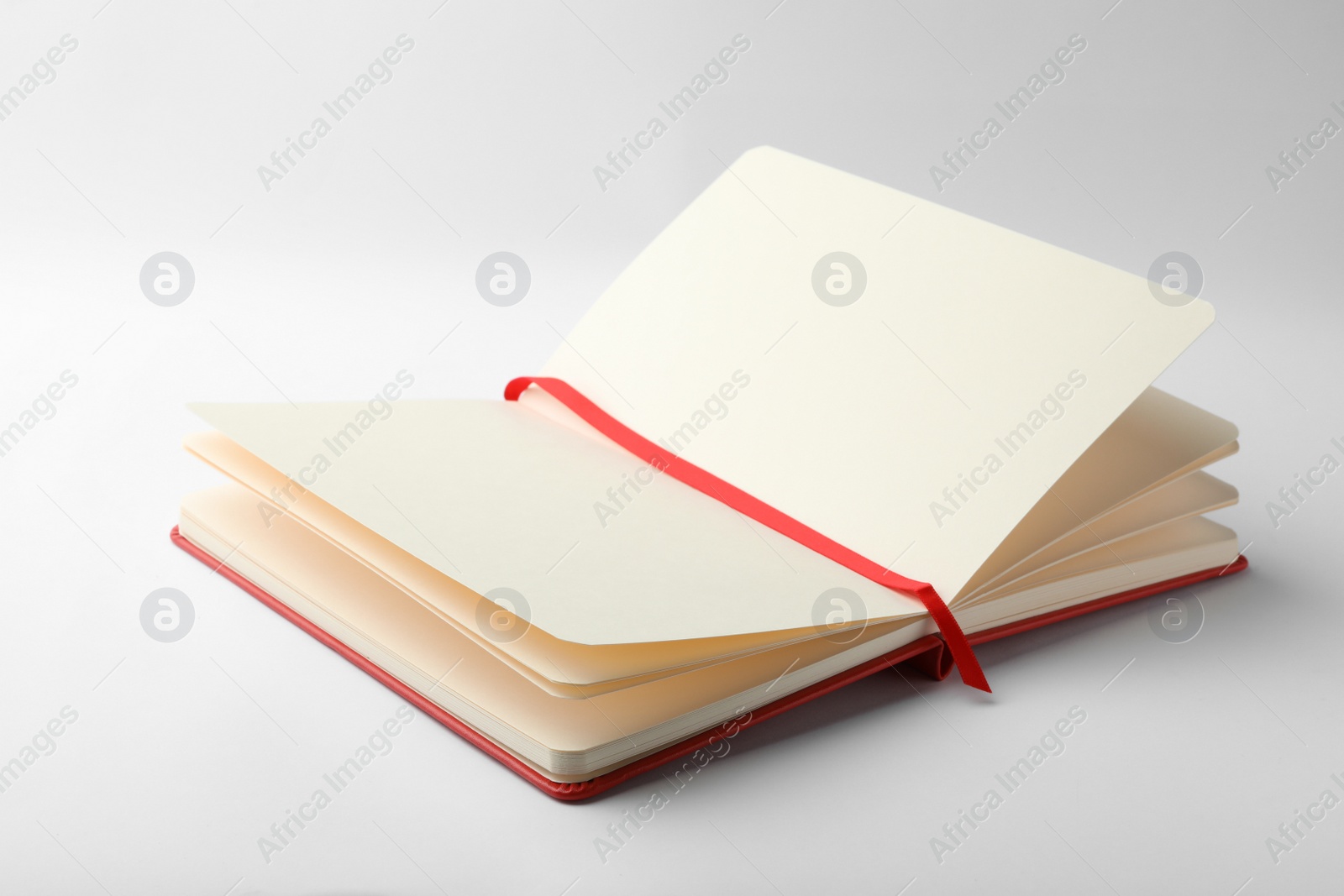 Photo of Stylish open notebook with blank sheets isolated on white