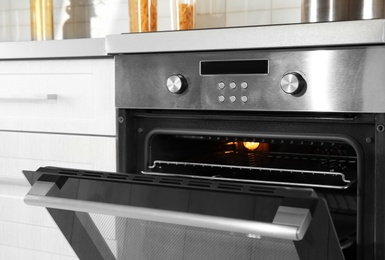 Photo of Open modern oven built in kitchen furniture