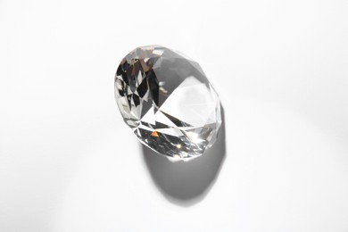 Photo of One beautiful shiny diamond on white background, top view