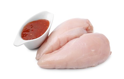 Marinade, basting brush, raw chicken fillets and chili peppers isolated on white