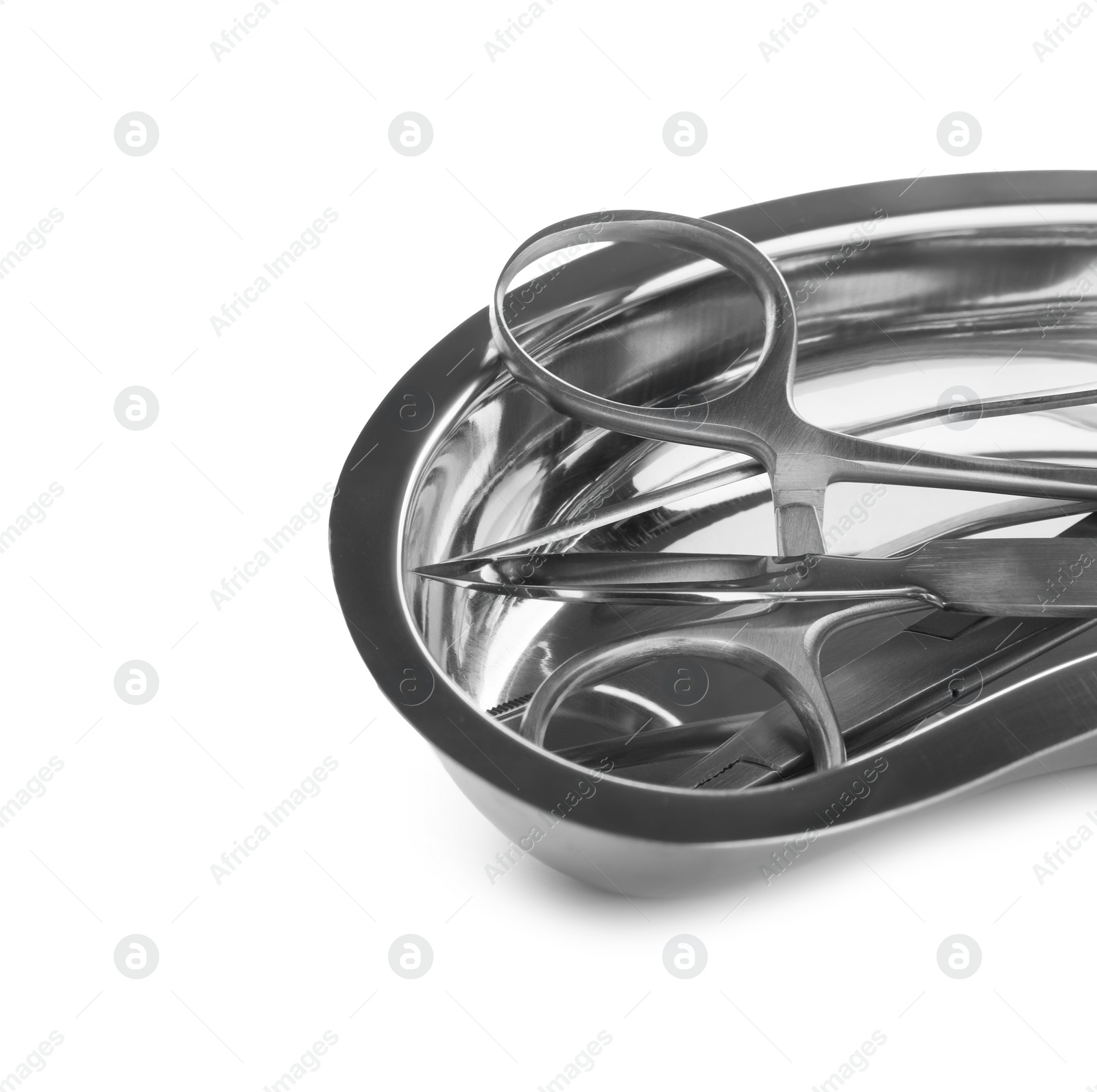 Photo of Surgical instruments in kidney dish on white background