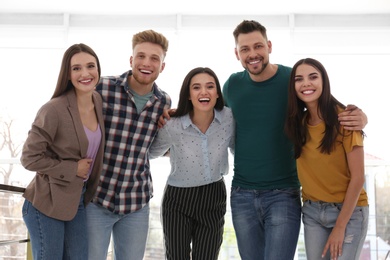 Group of happy people together in light room