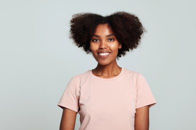 Photo of Portrait of smiling African American woman on light grey background