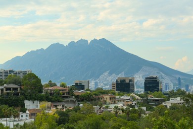 Beautiful landscape with city and green mountains