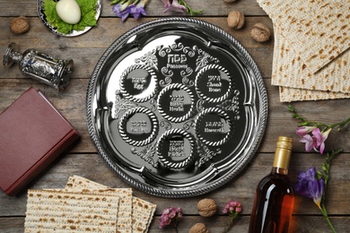 Photo of Flat lay composition with symbolic Passover (Pesach) items on wooden background