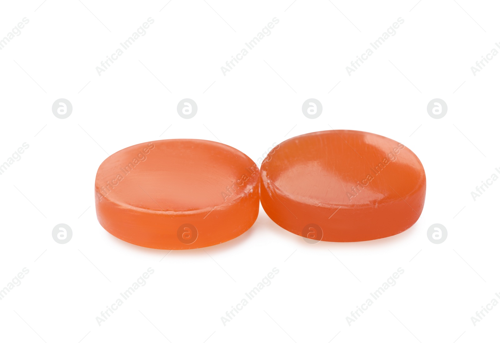 Photo of Two orange cough drops on white background