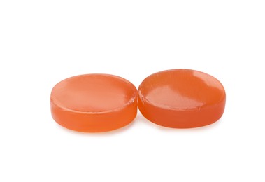 Two orange cough drops on white background