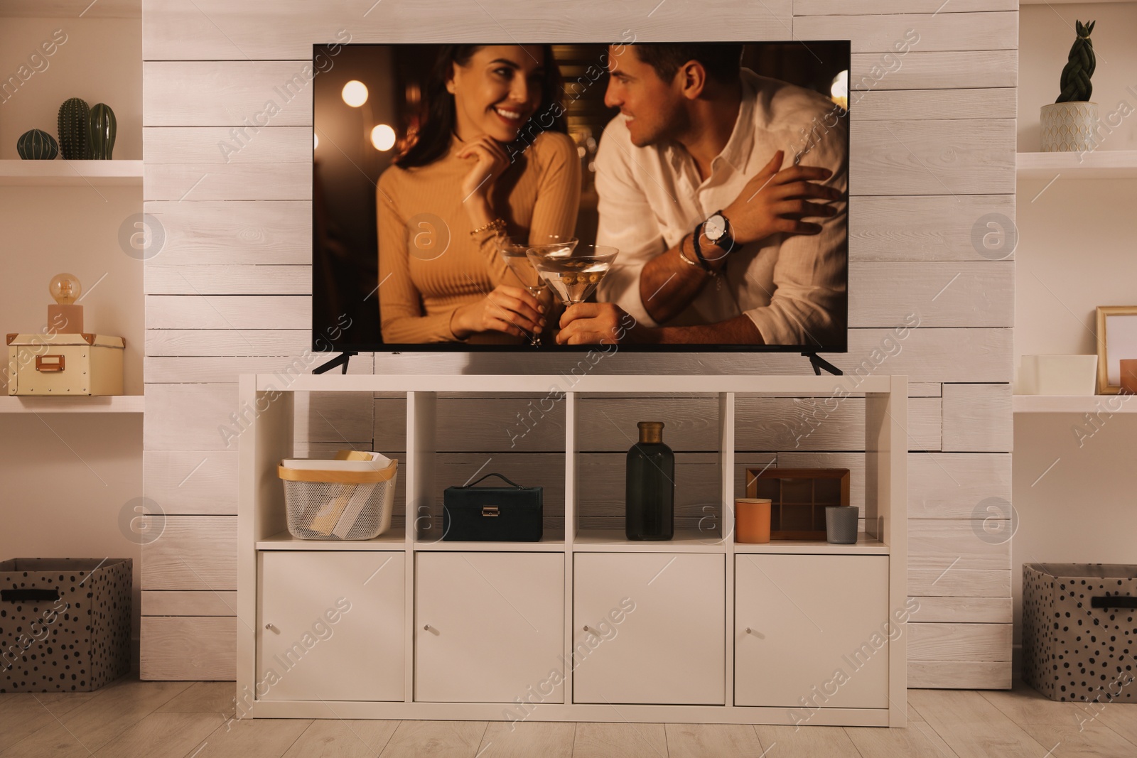 Image of Scene of romantic movie on TV in room