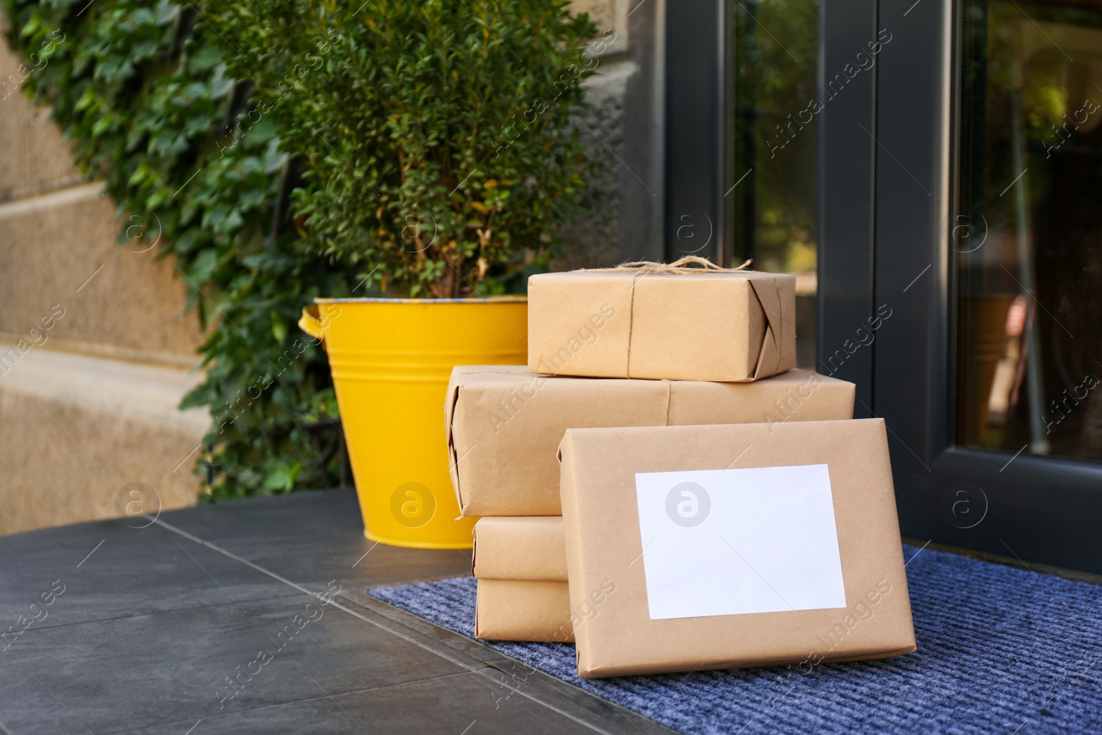 Photo of Delivered parcels on door mat near entrance