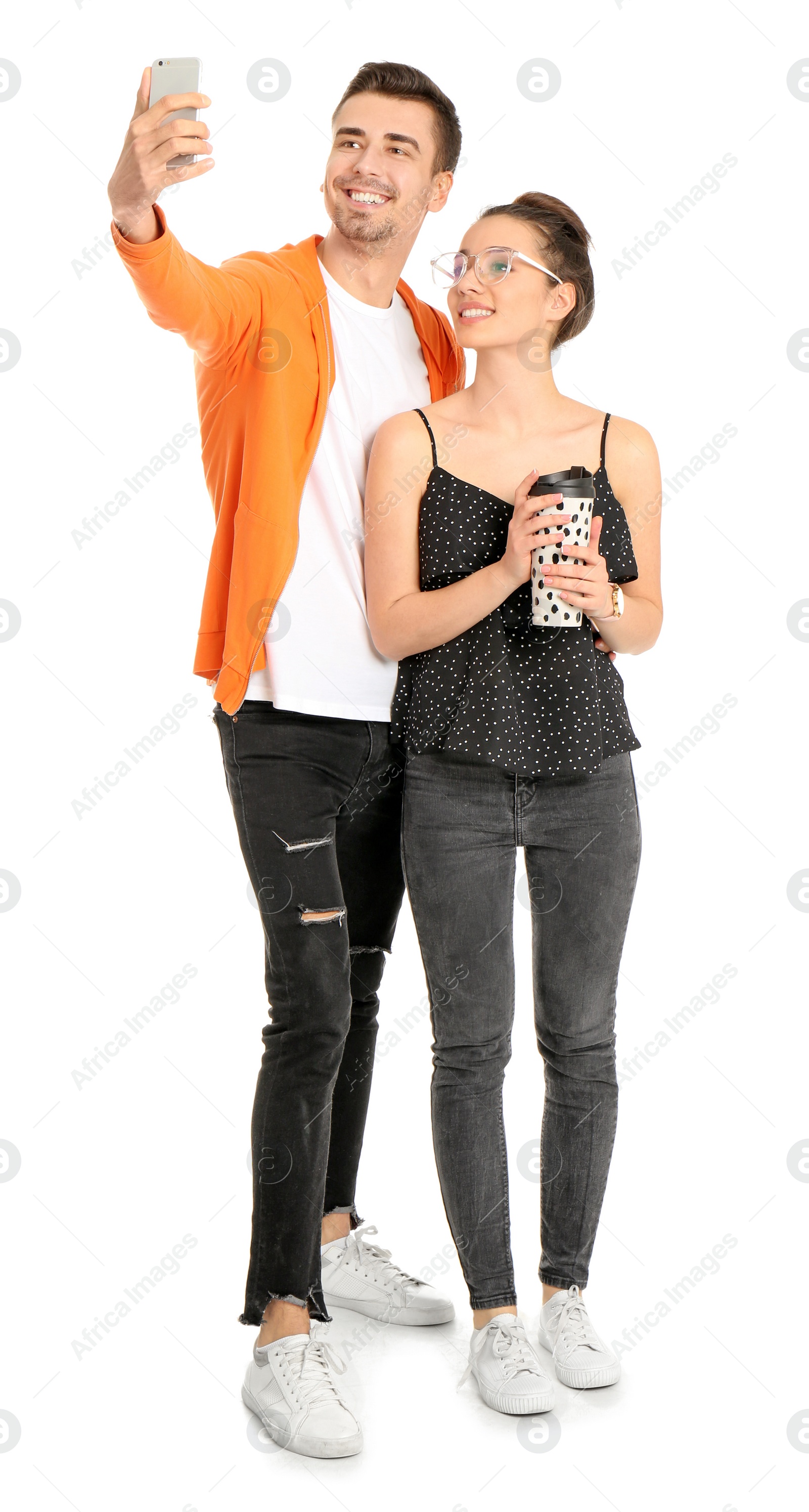 Photo of Young lovely couple taking selfie against white background
