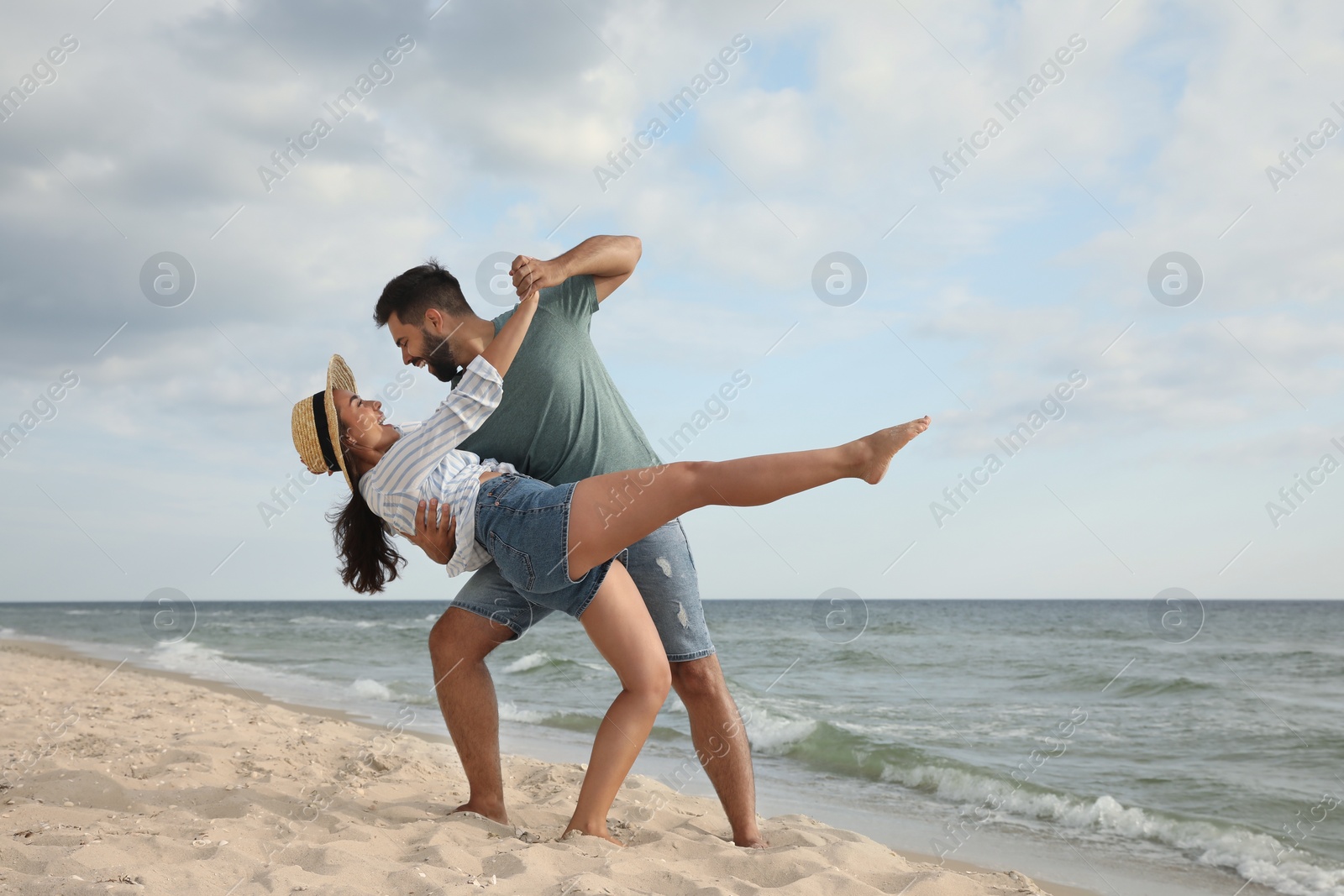 Photo of Lovely couple dancing on beach. Time together