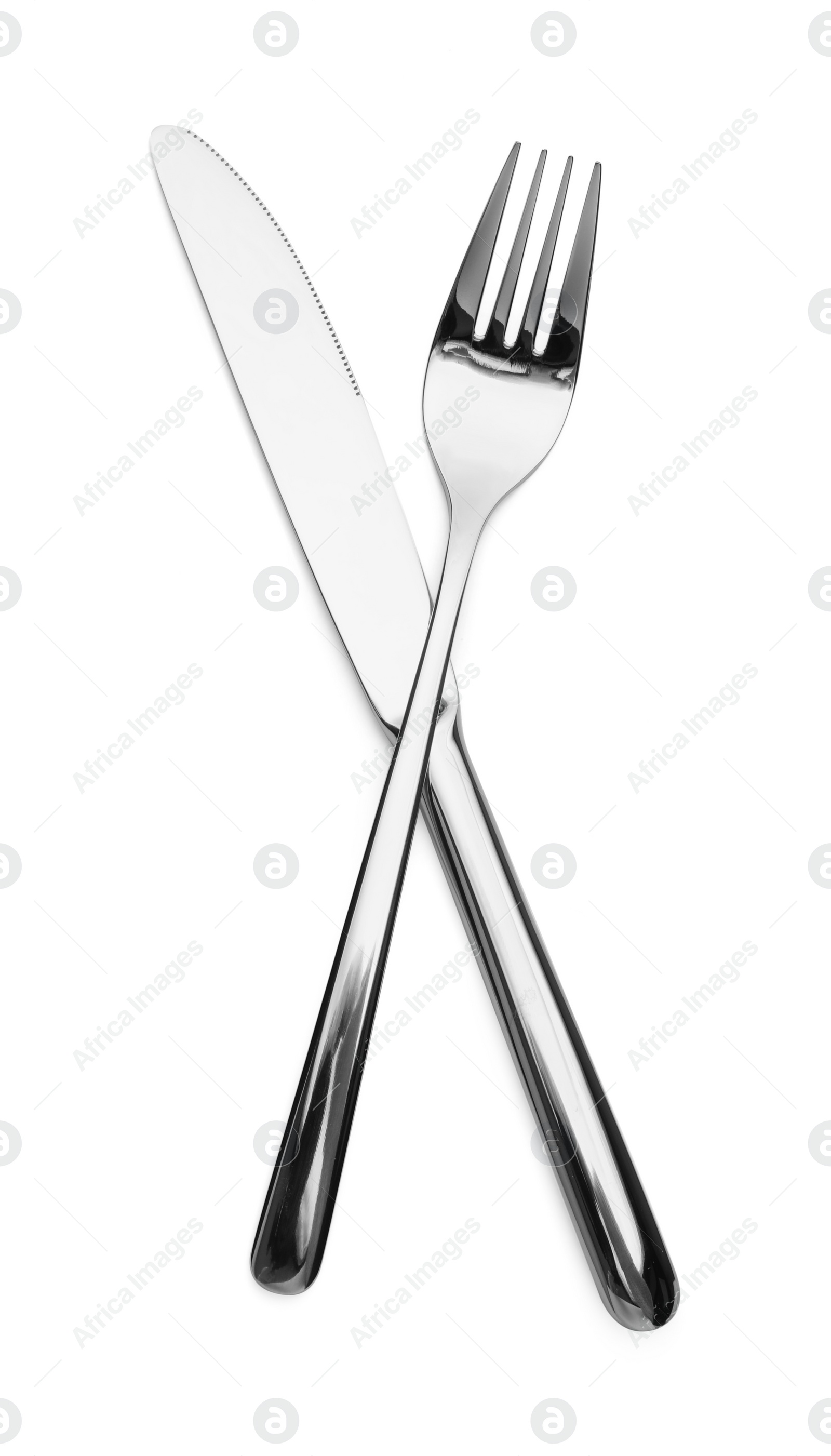 Photo of Shiny silver fork and knife isolated on white. Luxury cutlery