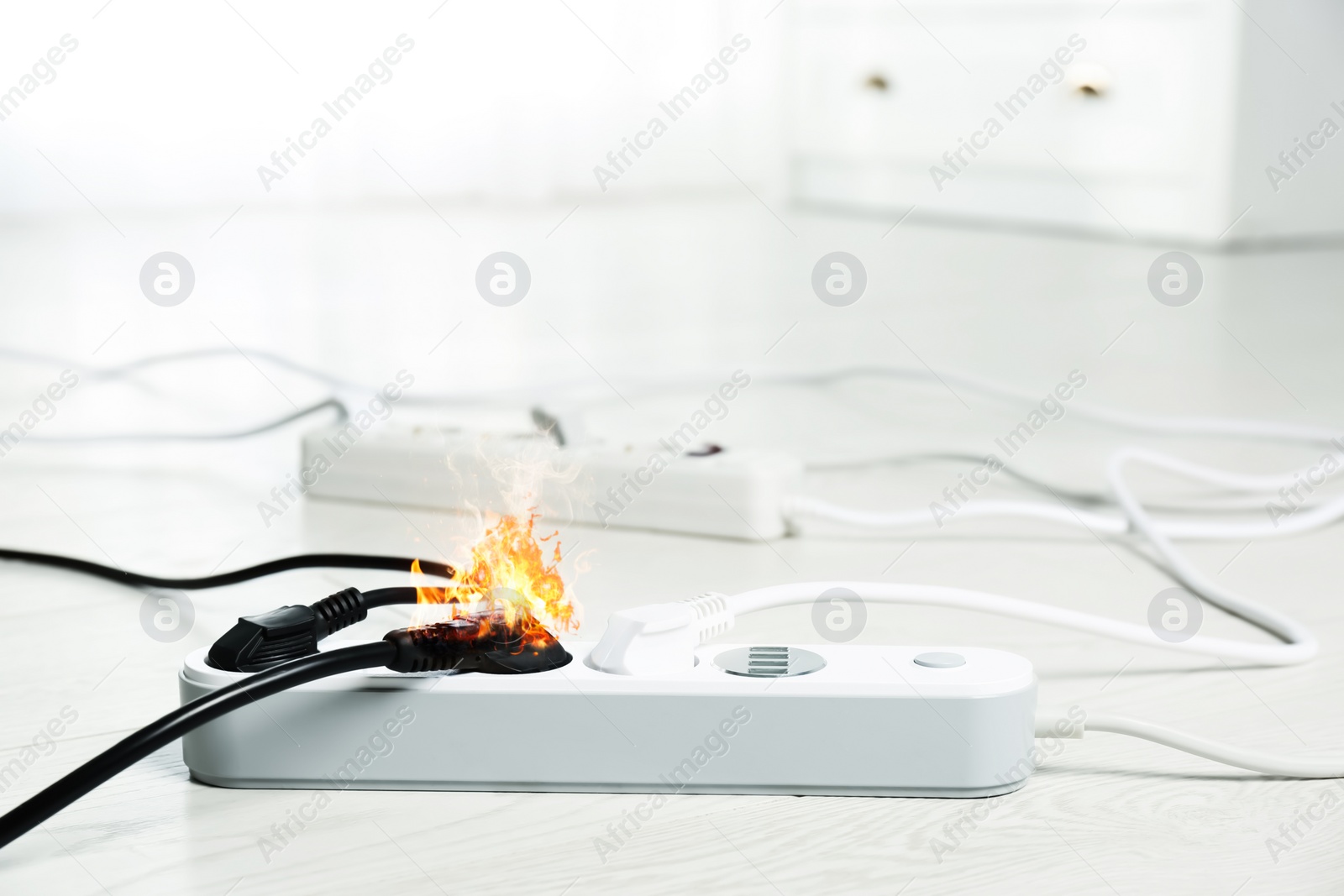 Image of Inflamed plug in power board - result of electrical short circuit