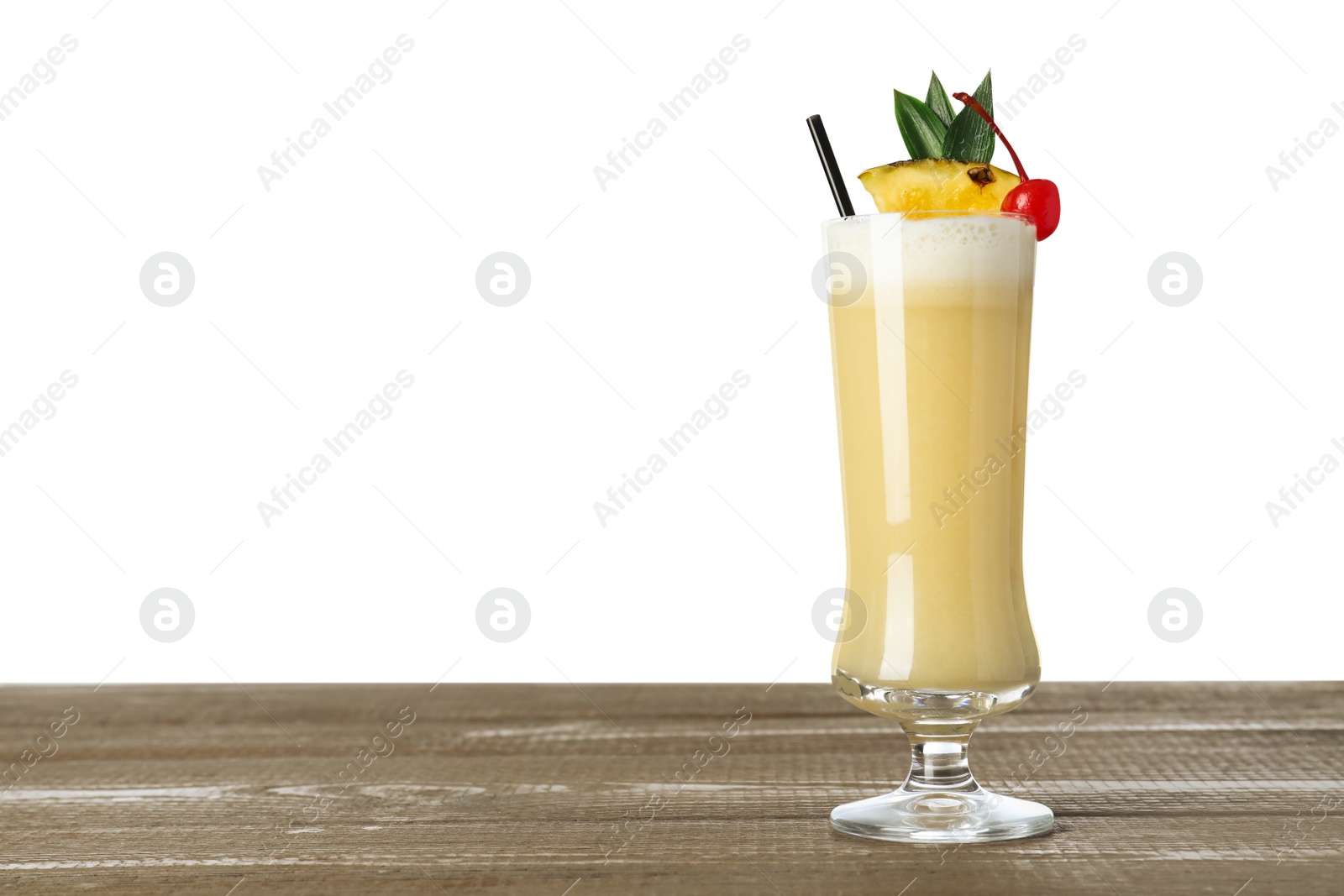 Photo of Tasty Pina Colada cocktail on wooden table against white background, space for text