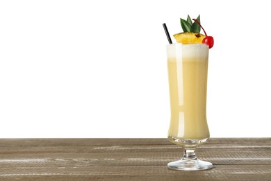 Photo of Tasty Pina Colada cocktail on wooden table against white background, space for text