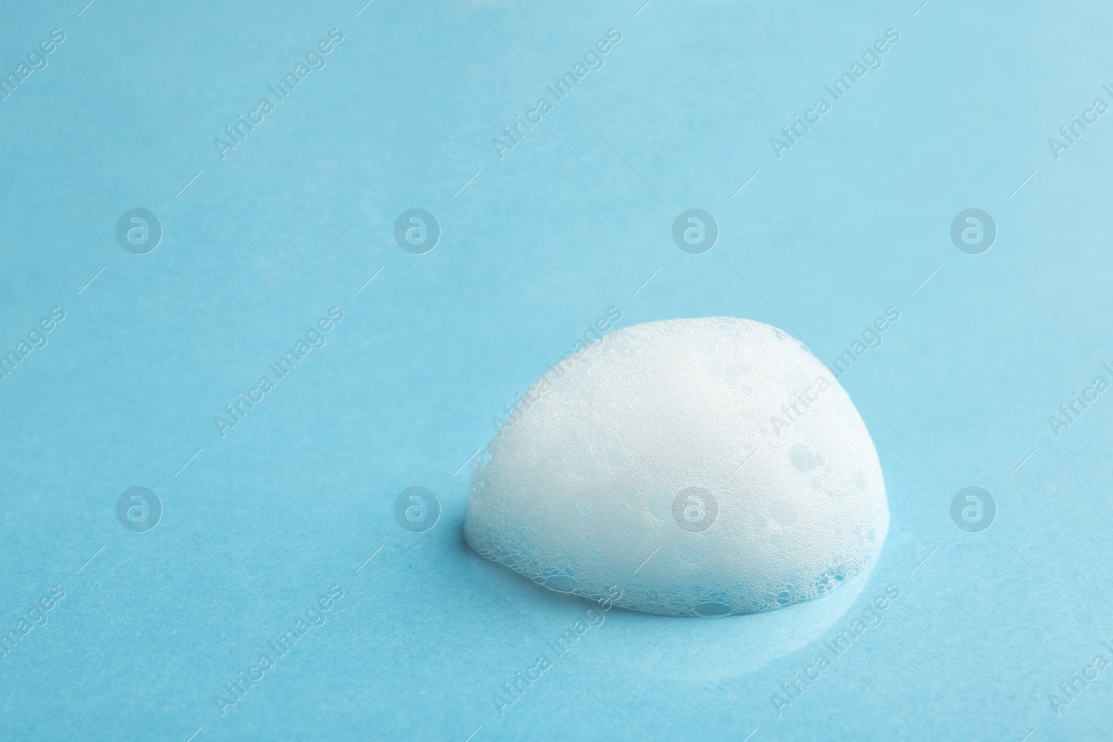 Photo of Drop of soap foam on color background. Space for text