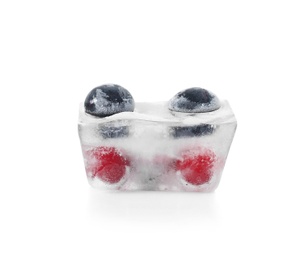 Photo of Raw berries frozen in ice cube on white background