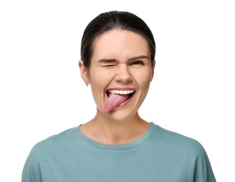 Photo of Happy young woman showing her tongue on white background