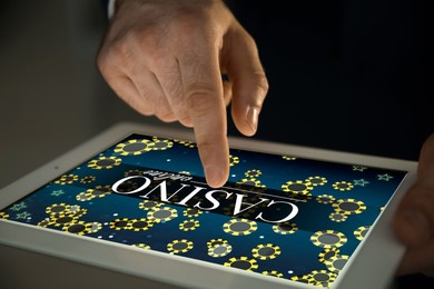 Man playing poker on tablet, closeup. Casino online