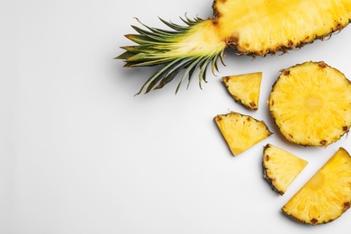 Composition with raw cut pineapple on white background, top view