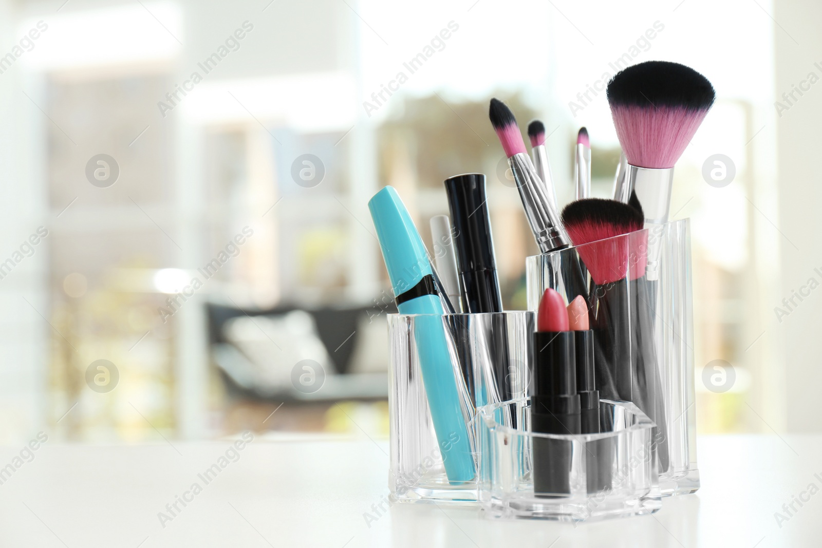 Photo of Organizer with makeup cosmetic products on table indoors. Space for text