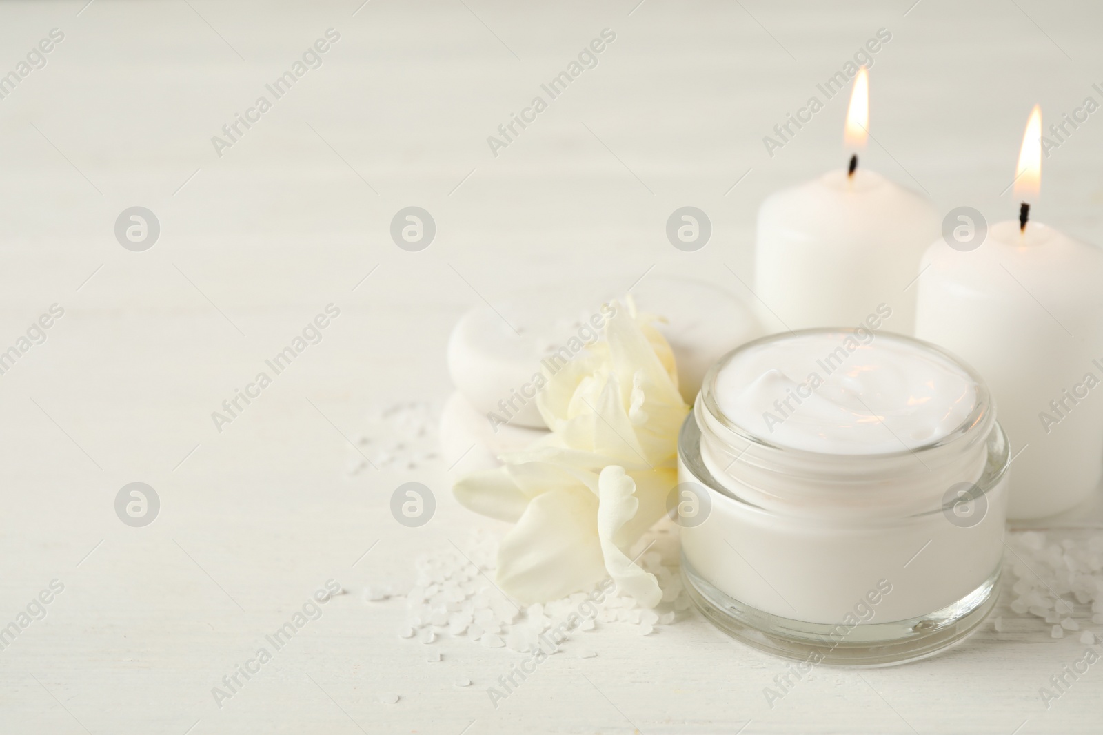 Photo of Composition with cream and spa stones on white table, closeup. Space for text