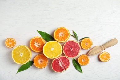 Photo of Different citrus fruits on wooden background, flat lay