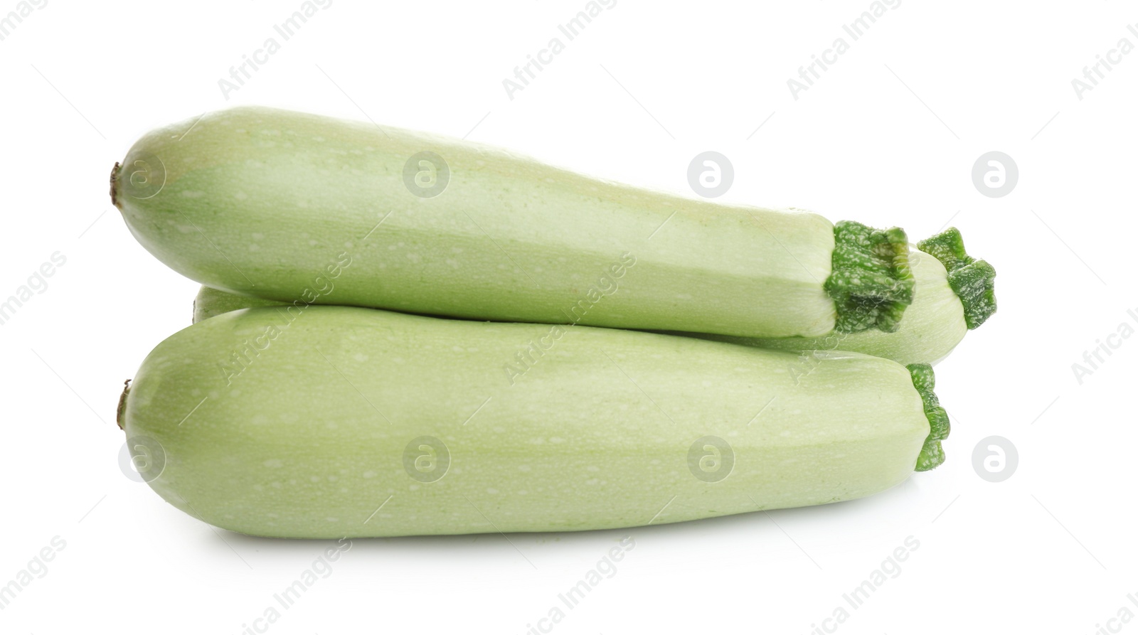 Photo of Fresh ripe green zucchinis isolated on white