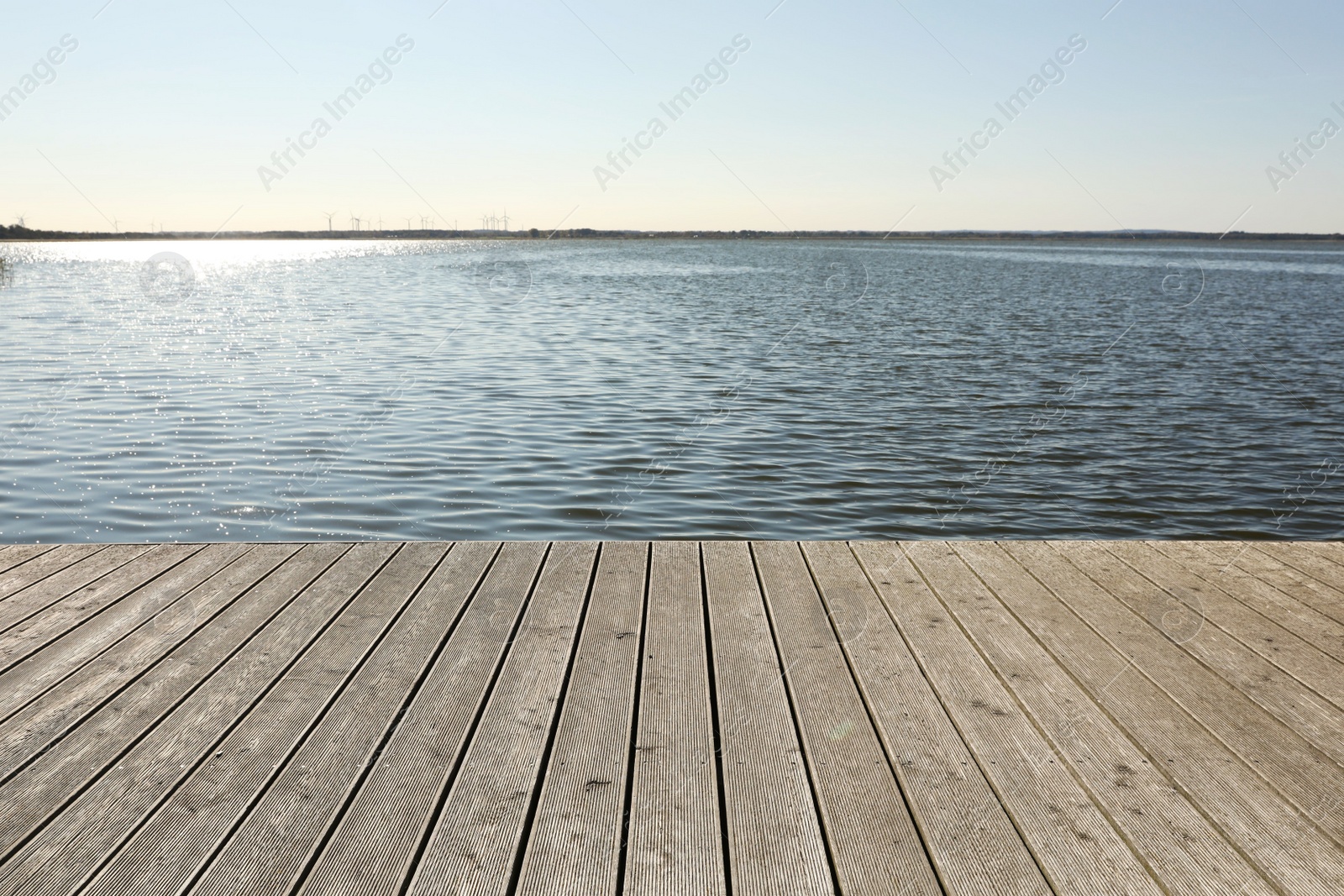 Photo of Beautiful view of wooden terrace near river on sunny day