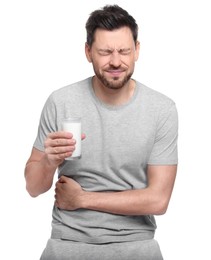 Photo of Man with glass of milk suffering from lactose intolerance on white background