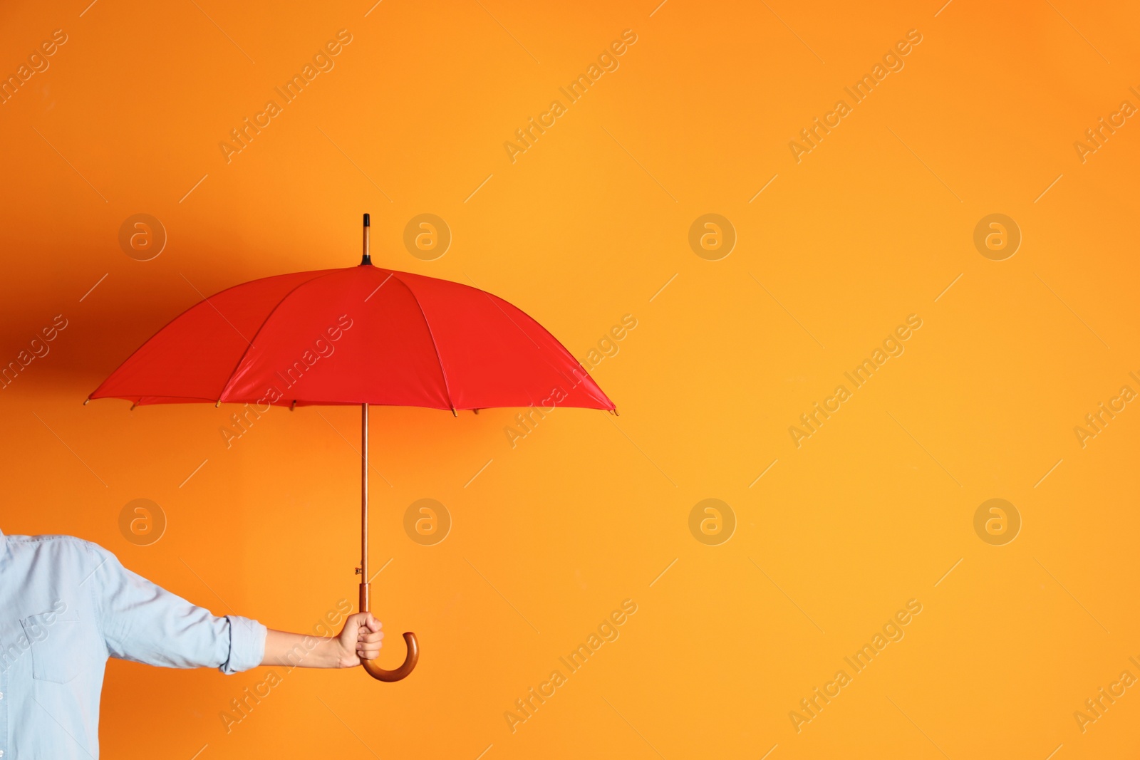 Photo of Woman holding beautiful umbrella on color background with space for design