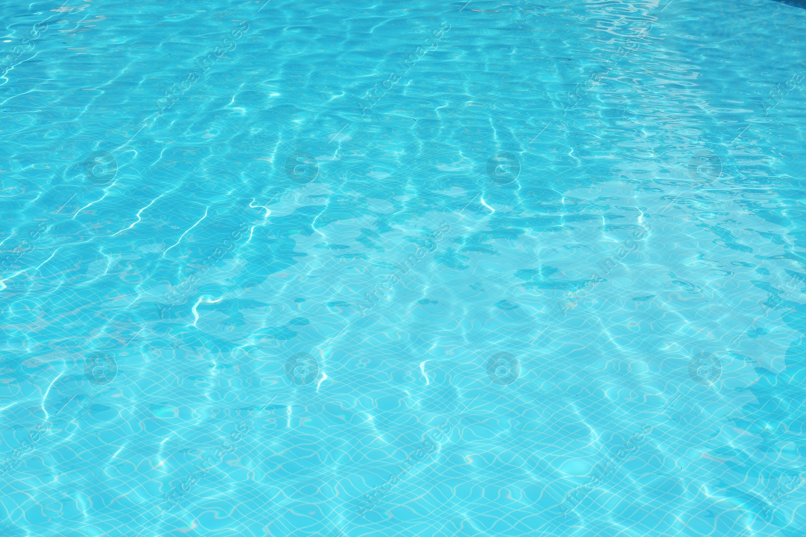 Photo of Clear refreshing water in swimming pool, closeup