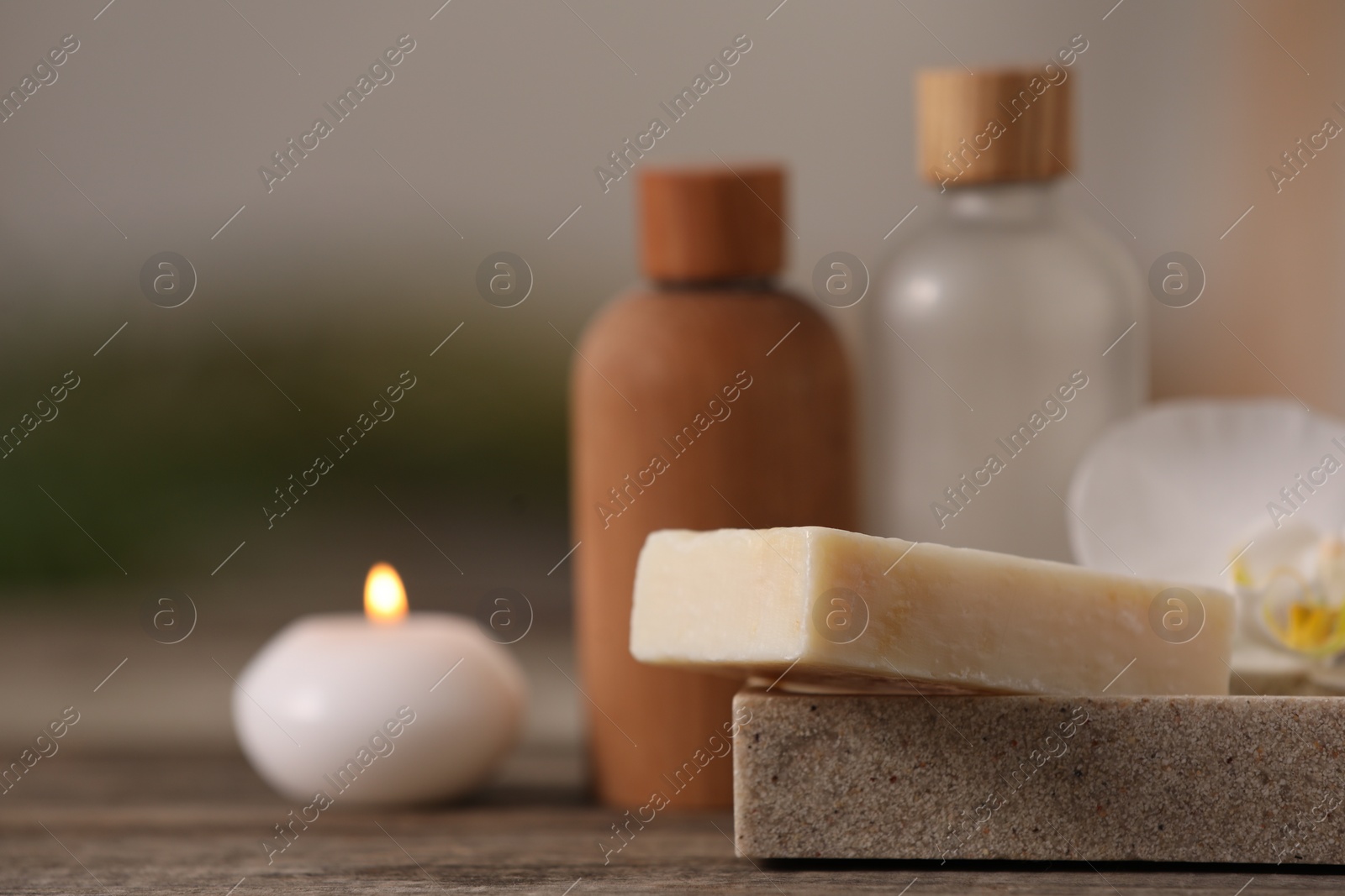 Photo of Composition with different spa products on wooden table against blurred background, closeup. Space for text