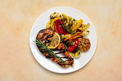 Photo of Tasty salmon steak with sauce, lemon and vegetables on light table, top view