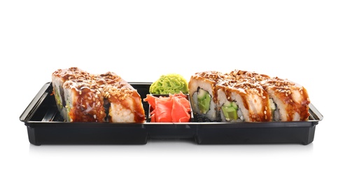 Box with tasty sushi rolls on white background. Food delivery