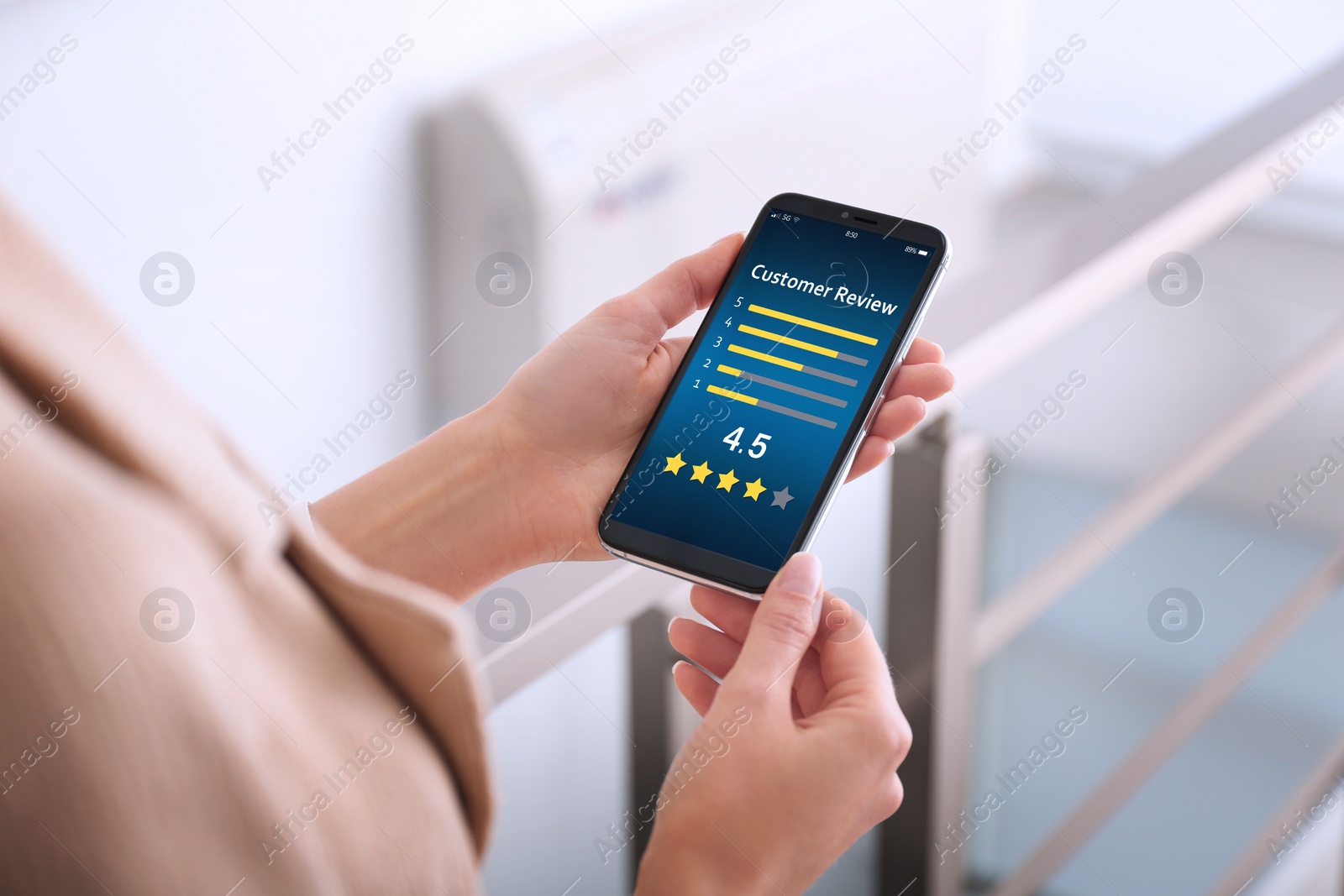 Image of Woman using smartphone to give feedback indoors, closeup. Customer review