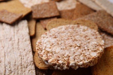 Photo of Fresh rye crispbreads, crunchy rice cakes and rusks as background, closeup