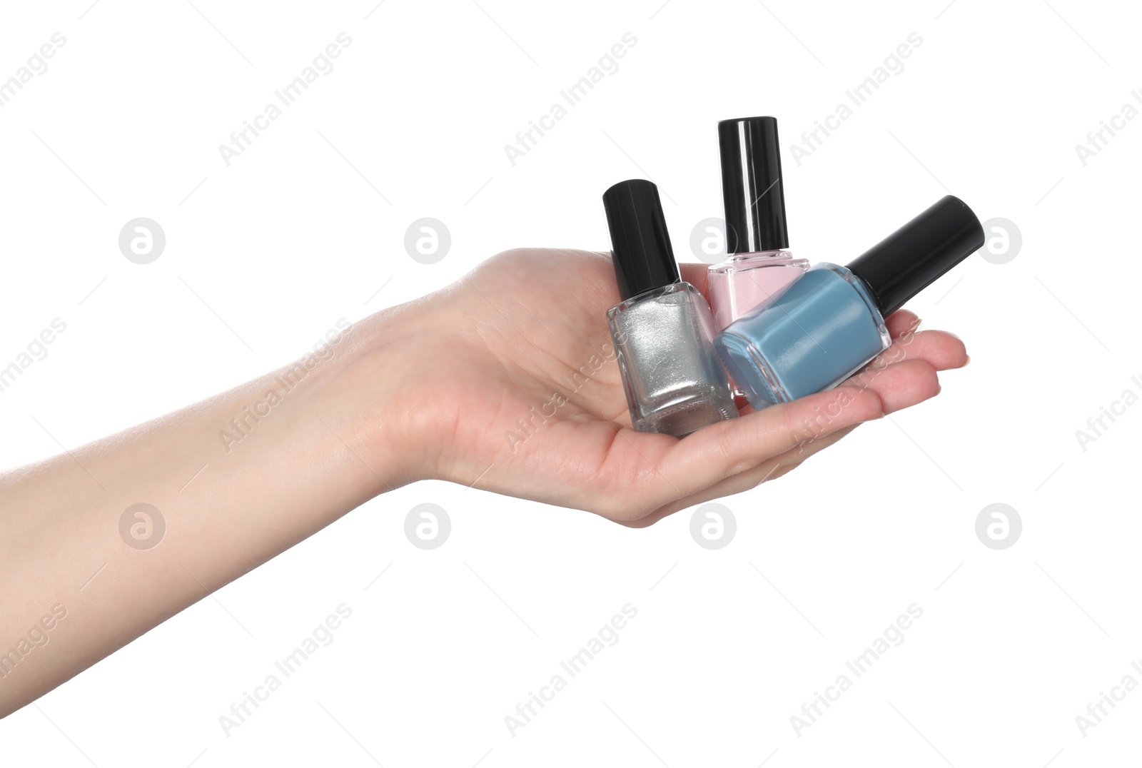 Photo of Woman holding nail polishes on white background, closeup