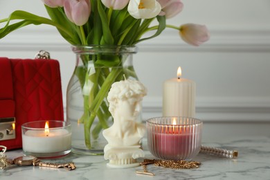 Photo of Stylish David bust candle on white marble table