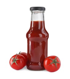 Photo of Glass bottle of tasty ketchup and fresh tomatoes isolated on white